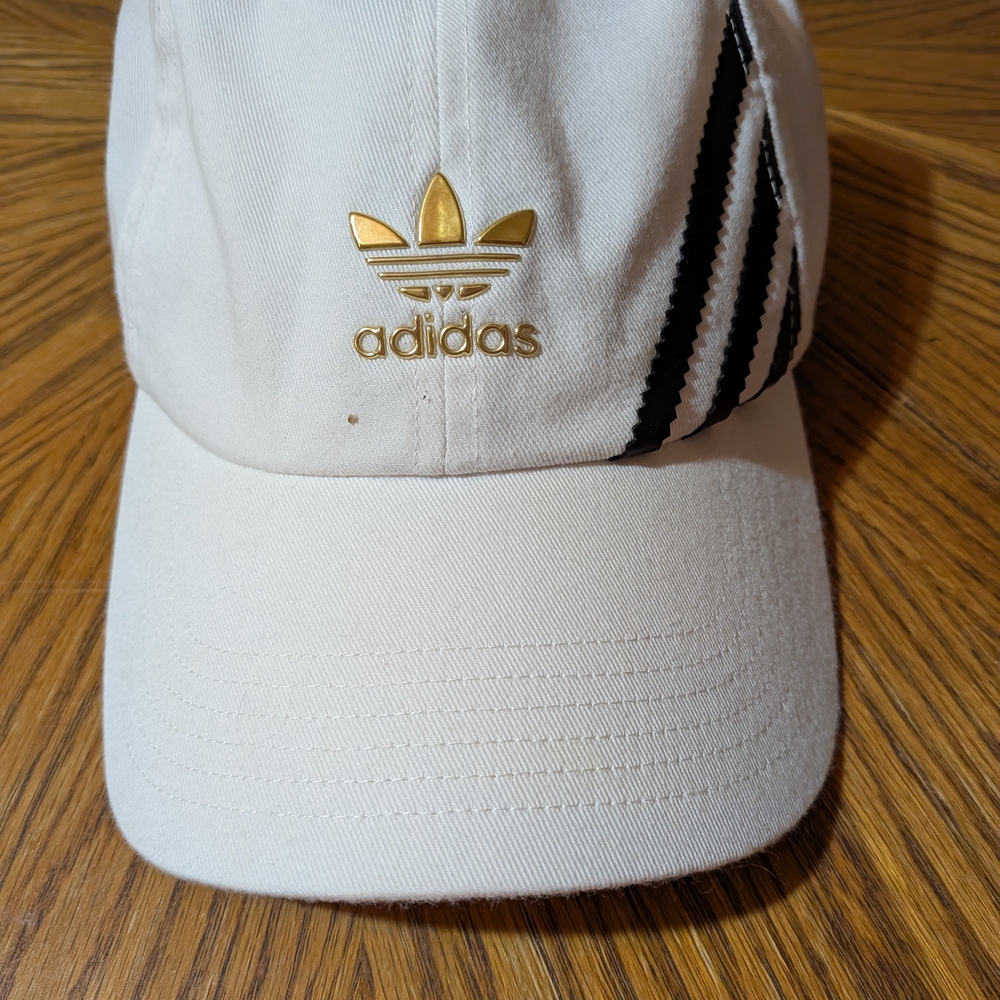 Adidas Cream Cap with Black Stripes and Gold Emblem